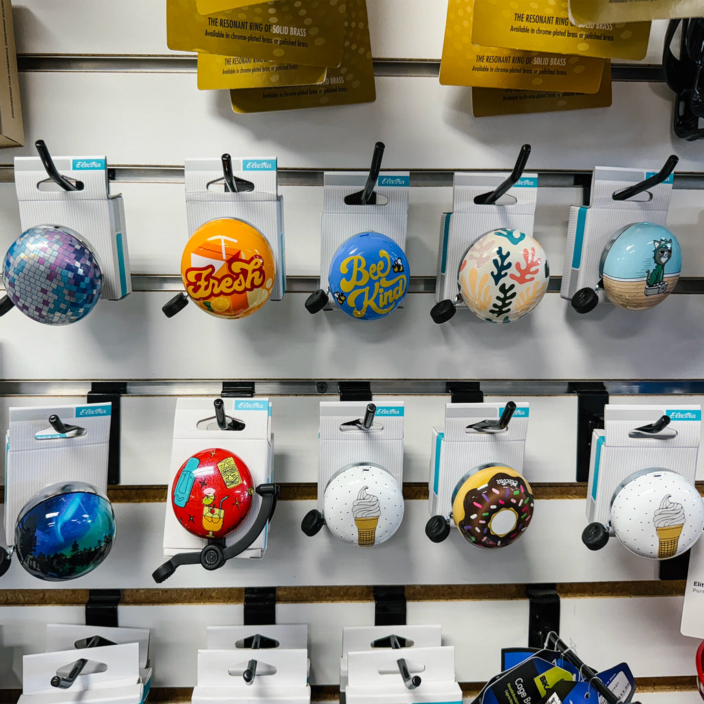 Electra bicycle bells complete collection wall display showing all graphic designs