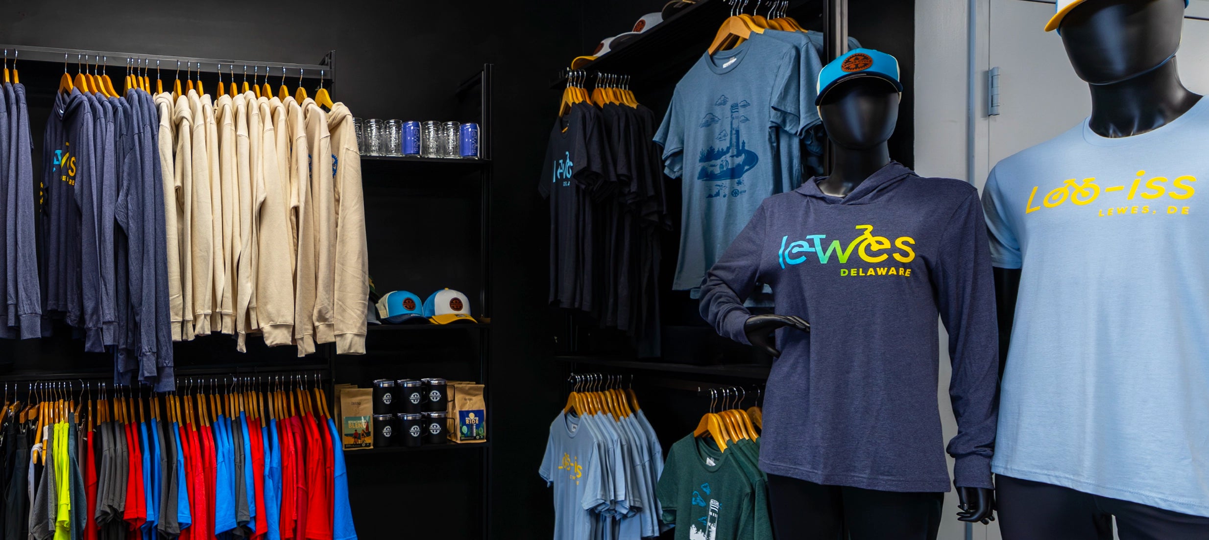 Lewes Cycle Sports bike shop interior showing branded merchandise and apparel display area