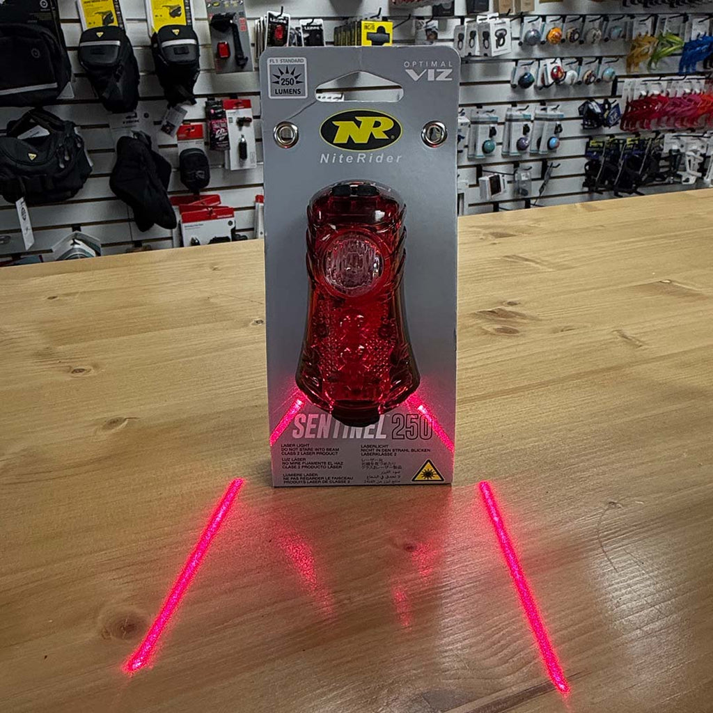 NiteRider Sentinel 250 taillight in packaging showing laser lanes feature