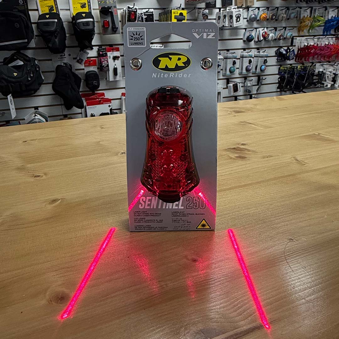 NiteRider Sentinel 250 taillight in packaging showing laser lanes feature